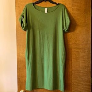 Green T-shirt dress with pockets.